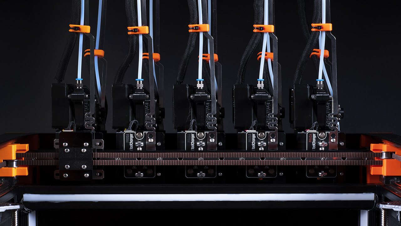 Five Prusa XL Nextruders next to each other on the printer